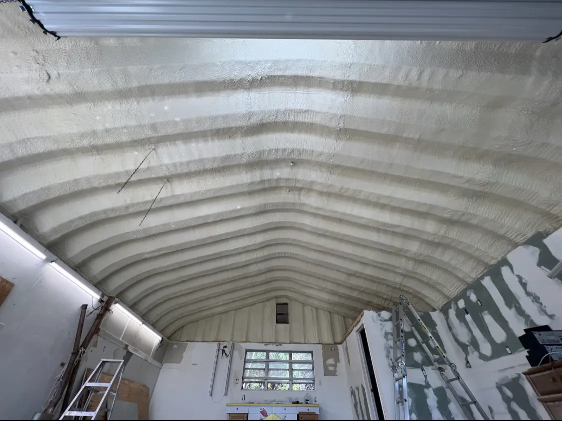Spray polyurethane foam applied to the underside of a metal roof deck in Douglass